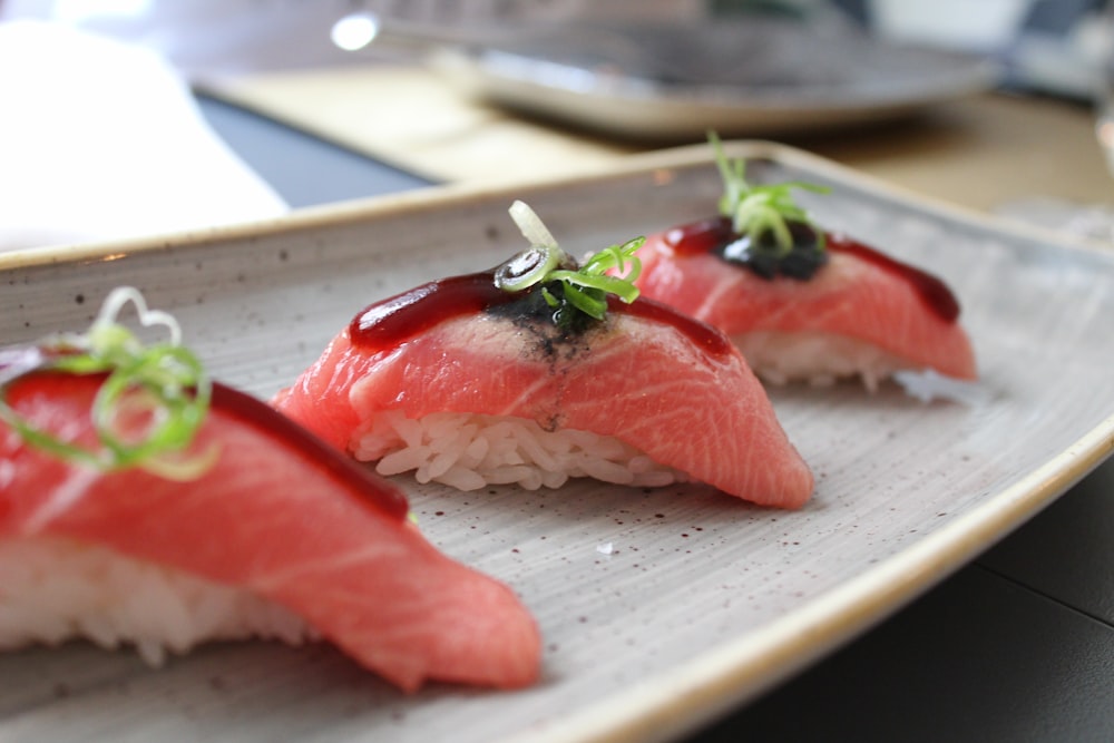 rice wrapped with fresh fish with garnish on top