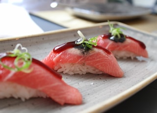 rice wrapped with fresh fish with garnish on top