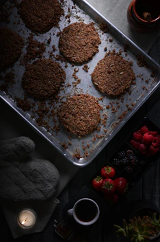 six brown patties in stainless steel baking pan
