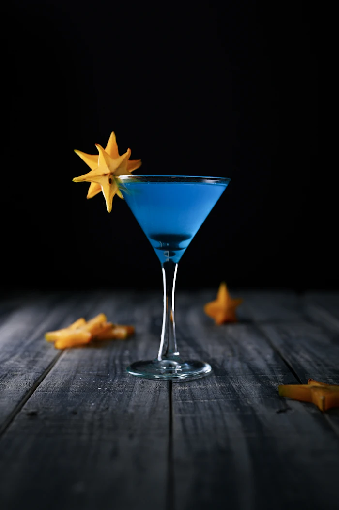 Blue liquor cocktail in a coupe glass