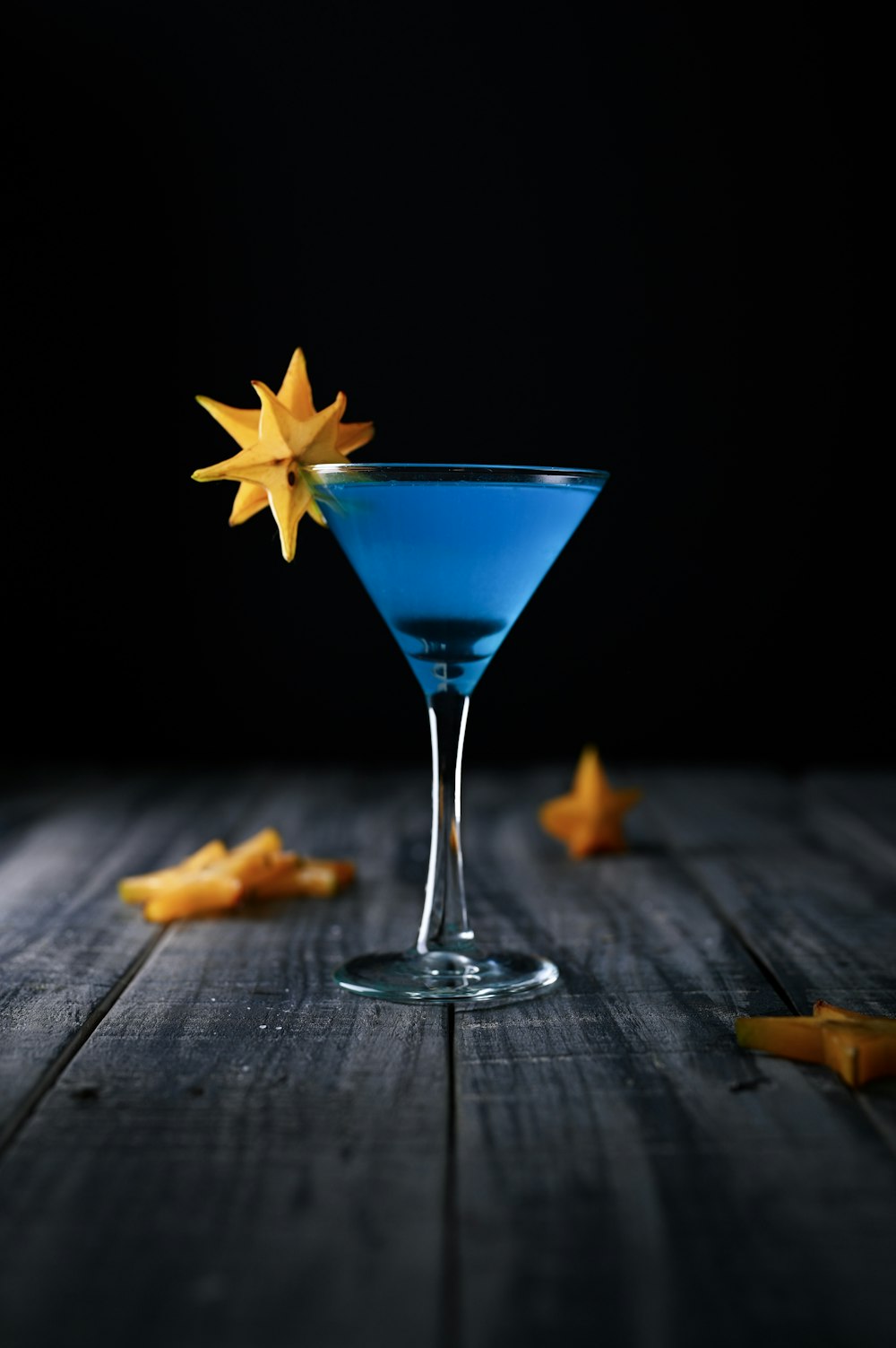 blue liquor in clear cocktail glass