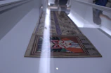 Close-up of a detailed painting displayed during a national art exhibition.