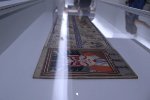 Close-up of a detailed painting displayed during a national art exhibition.