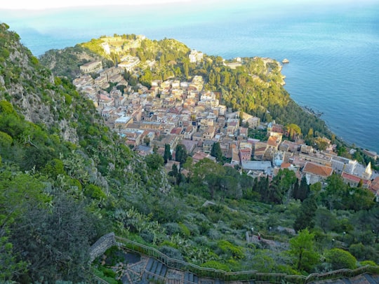 town houses below mountain fronting the sea in Taormina Italy