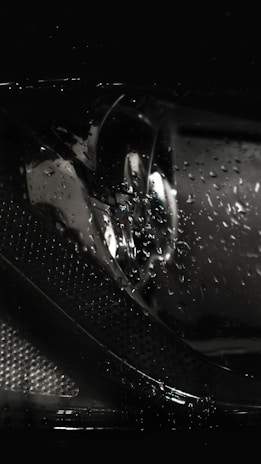 Before-and-after view of a headlight restored to crystal-clear brightness from dull and foggy.