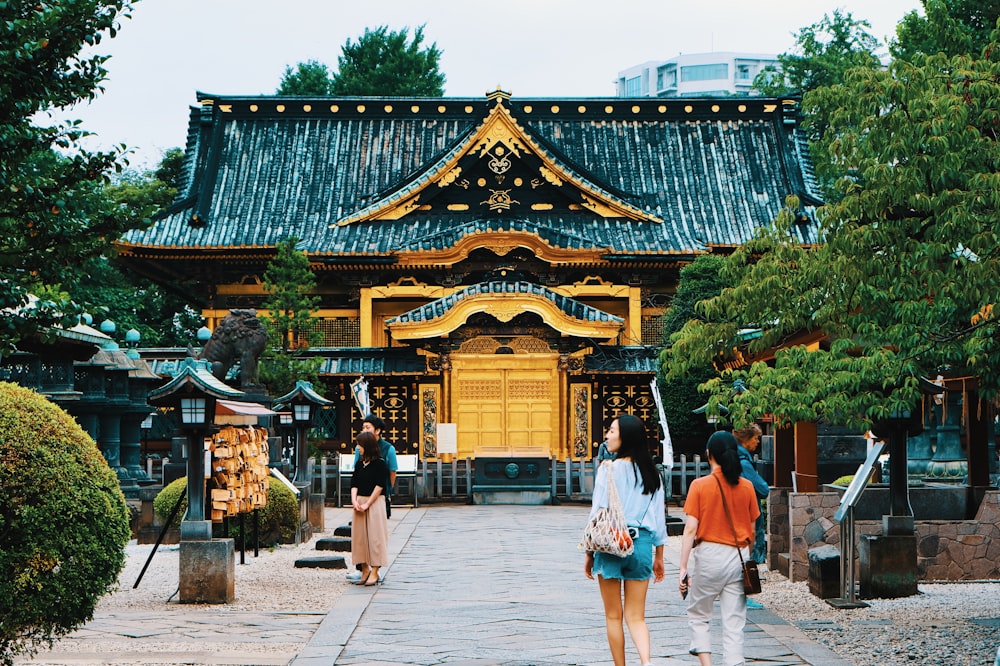 people near gold and blue temple during daytime