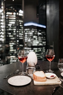 two clear wine glasses with red wine