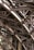 Intricate metal beams and structures form an elaborate framework, showcasing industrial design and engineering. The complex web of girders features rivets and cross-bracing against a backdrop of masonry.