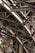 Intricate metal beams and structures form an elaborate framework, showcasing industrial design and engineering. The complex web of girders features rivets and cross-bracing against a backdrop of masonry.