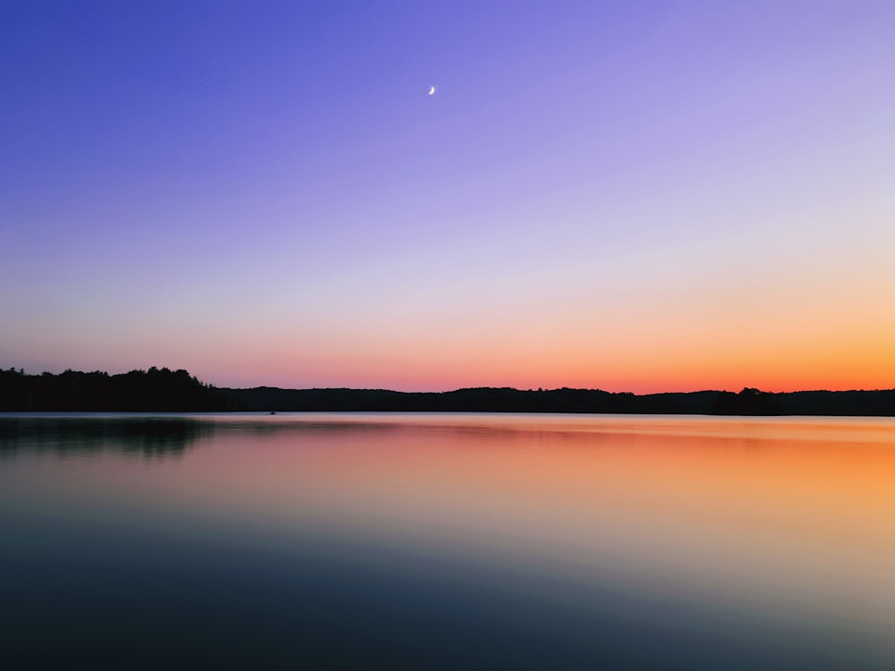 body of water during sunset