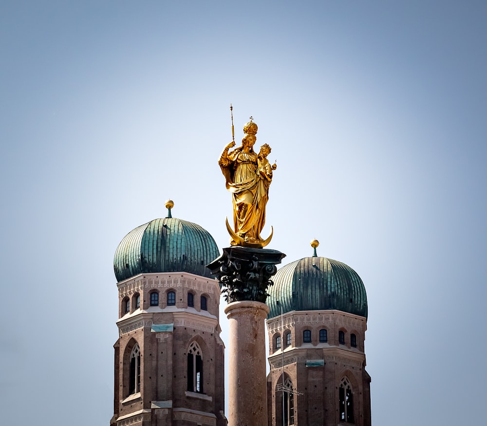 gold-colored statue during daytime