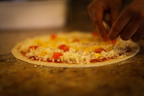 The friendly team at Dante's Pizzeria tossing dough behind the counter.