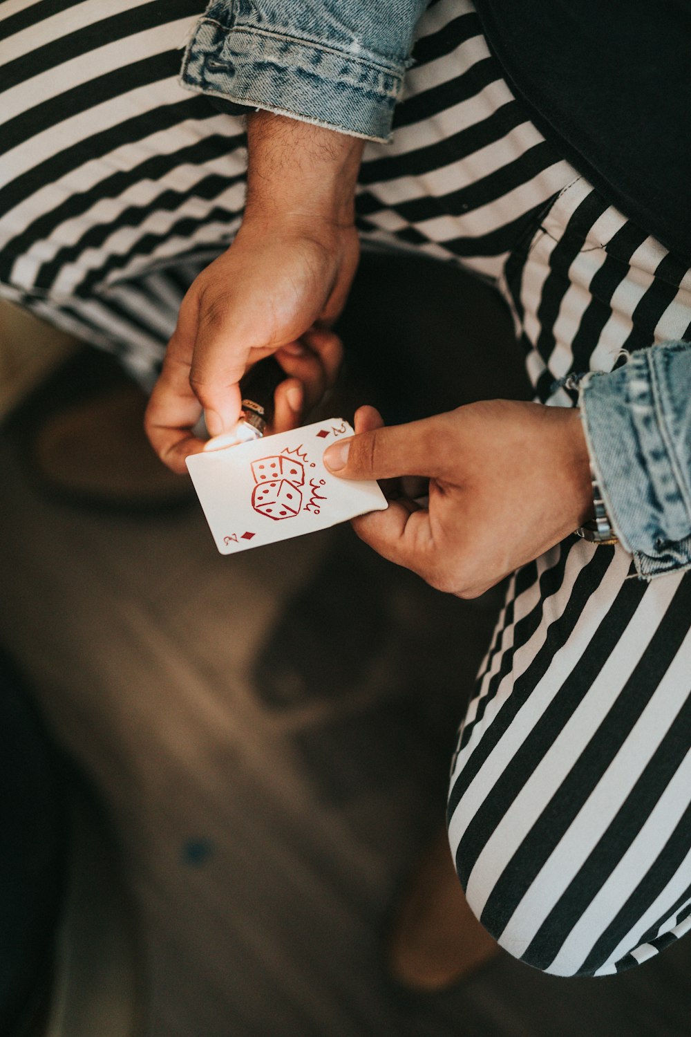 man holding playing card