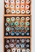 An artistic arrangement of sewing tools and colorful threads.