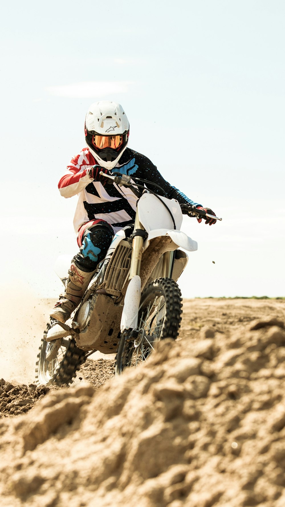 man riding motocross motorcycle