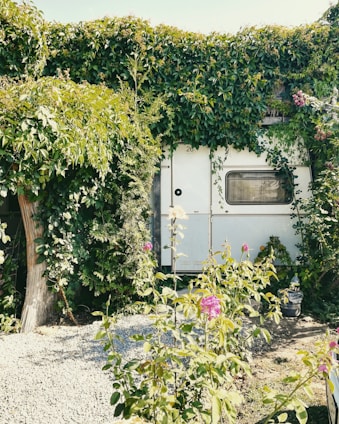 Vintage floral bouquet with pastel roses and greenery inside a cozy retro caravan.