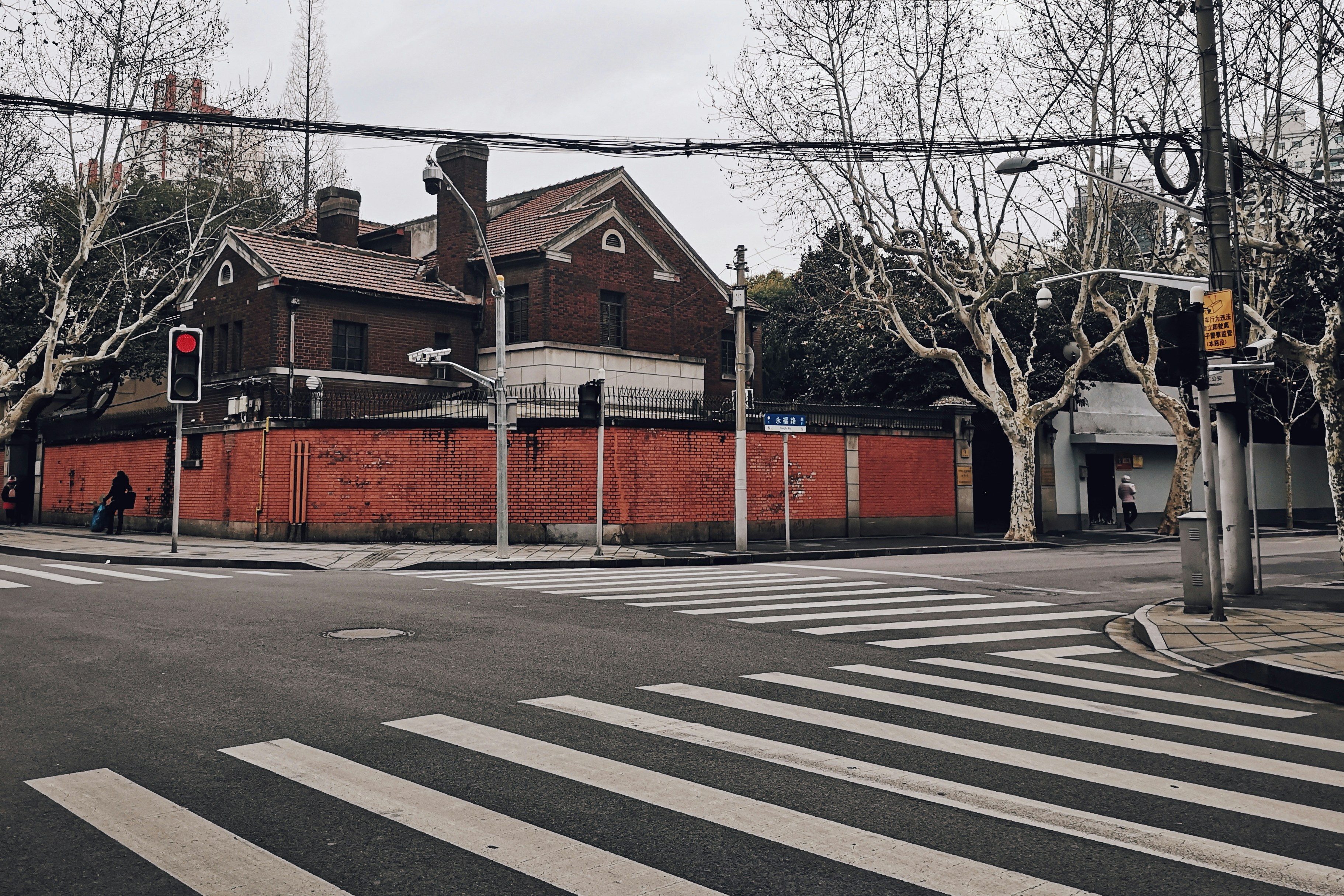 brown and red wooden house beside concrete pavement during daytime
