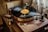 A vintage wooden turntable with a vinyl record spinning on it, set in a warm and cozy atmosphere. The record's label is clearly visible, and the tonearm is positioned over the grooves. Nearby objects include a small amplifier and various electronic components.