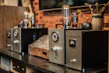 Sleek boutique pro audio amplifiers stacked in a cozy studio corner