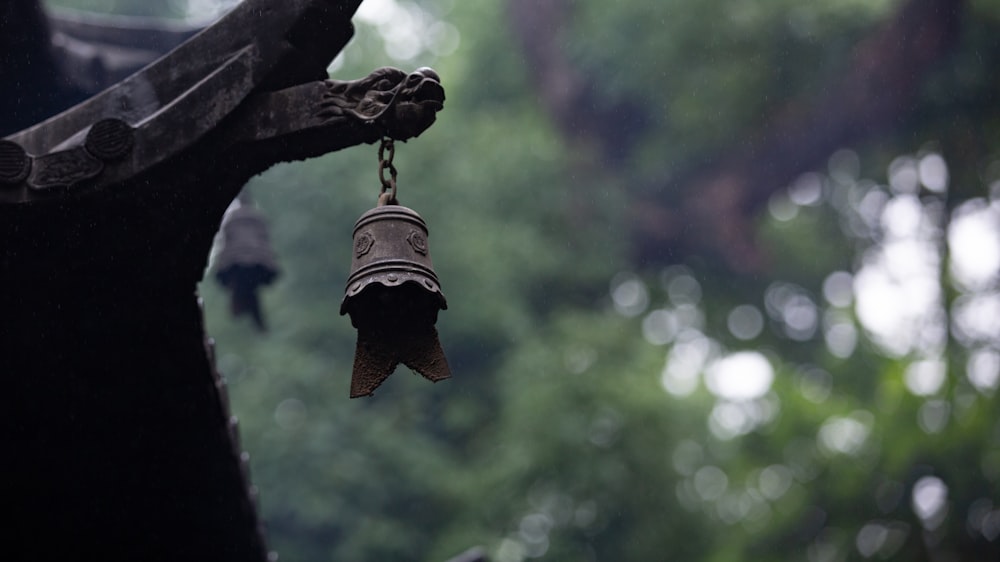 hanging bell near tree