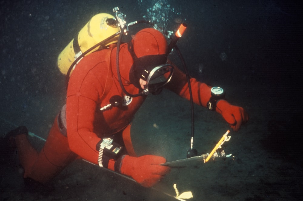 person in red wetsuit underwater