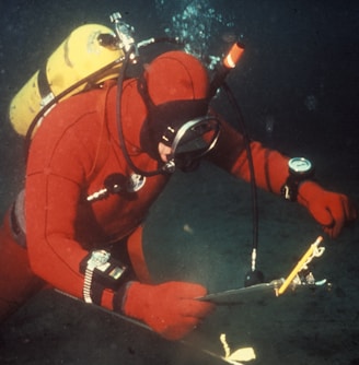 person in red wetsuit underwater