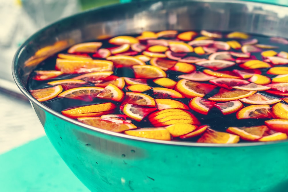 sliced orange fruits on body of water