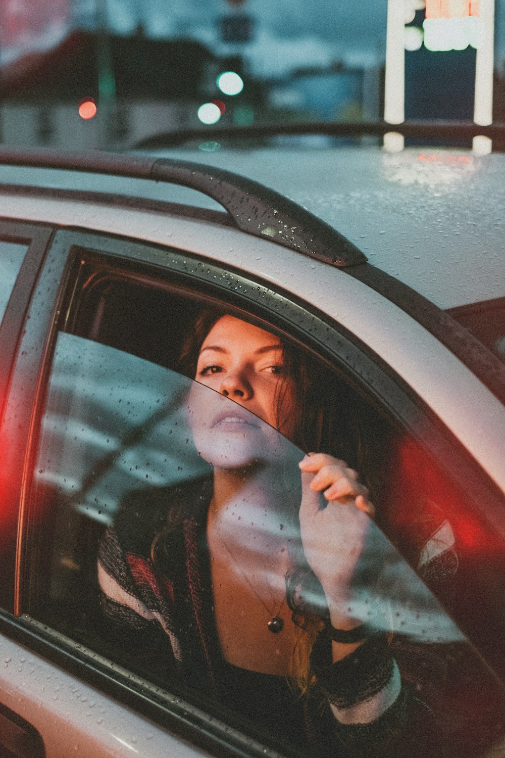 woman inside vehicle holding opened window