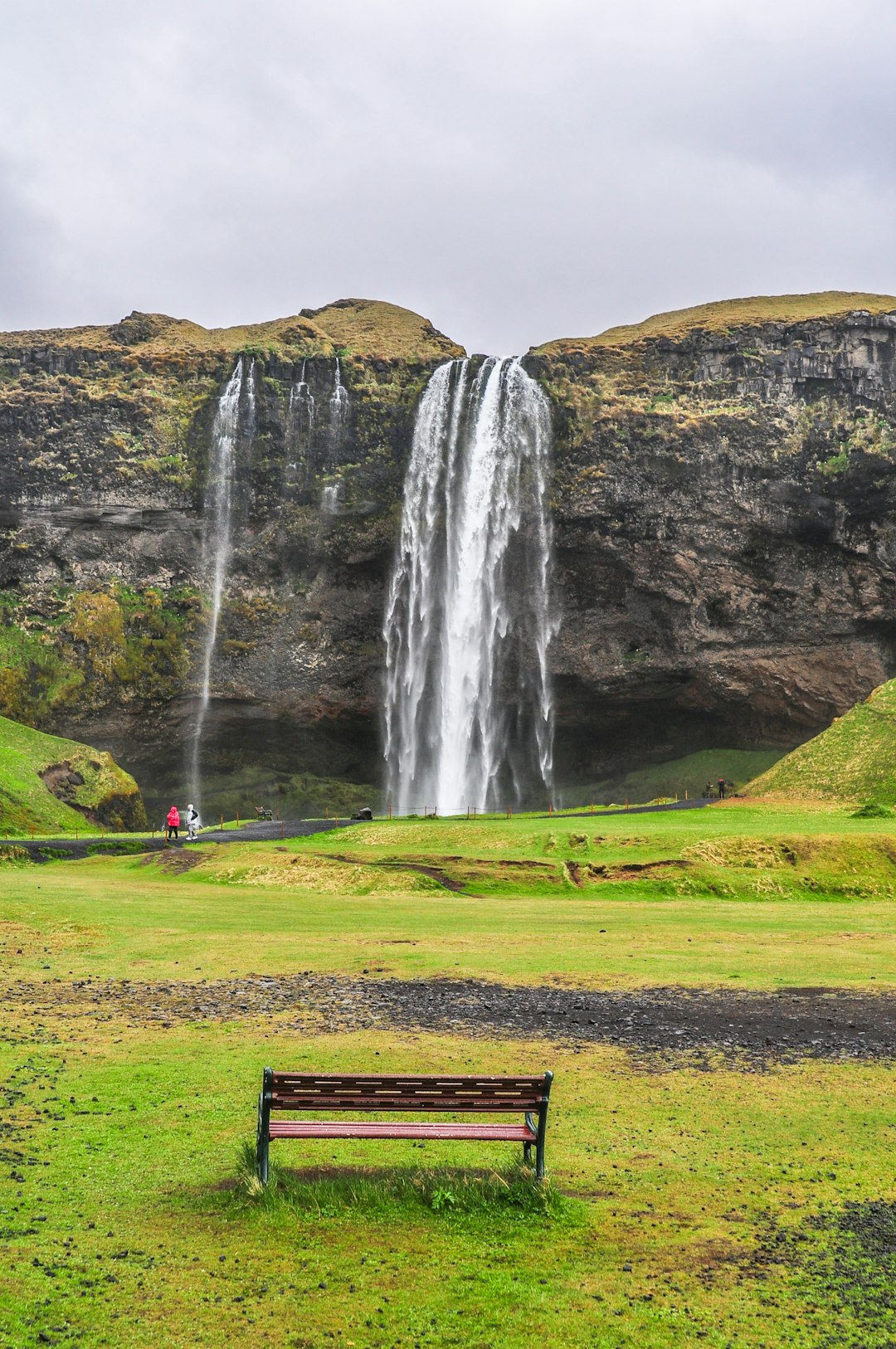 brown bench near waterfalls