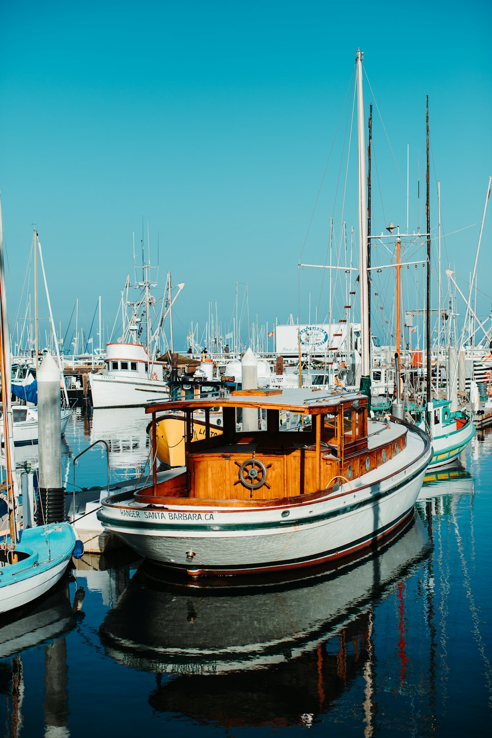 white and yellow boat under blue sky