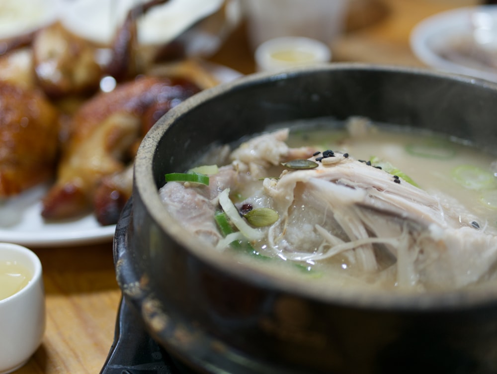 white soup on black ceramic pot