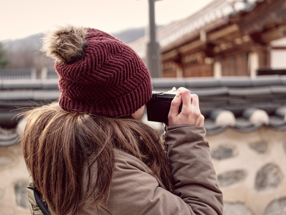 unknown person using black camera outdoors