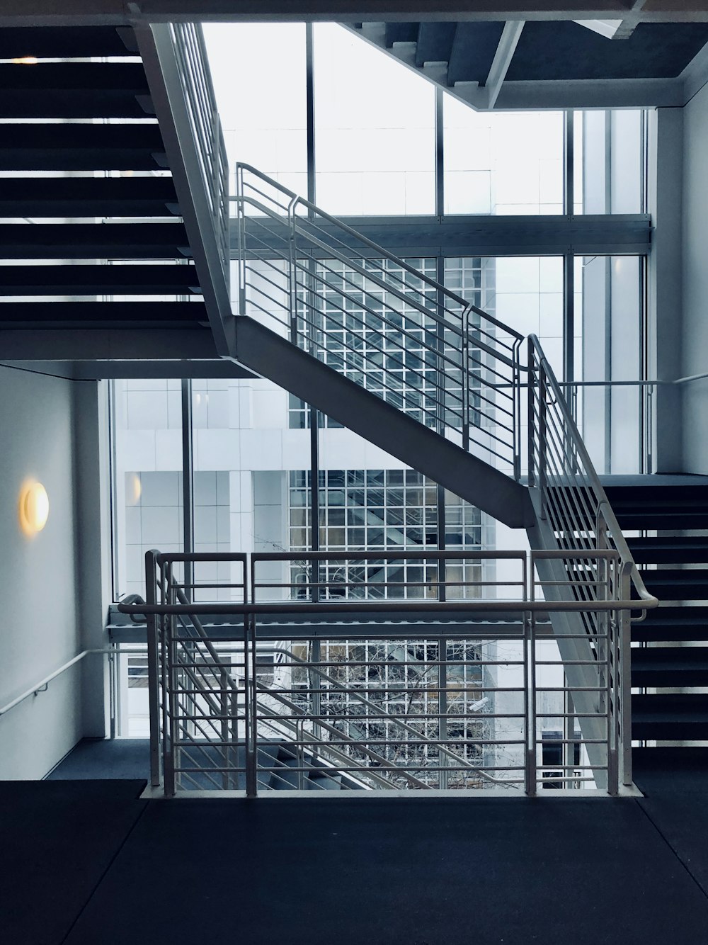 architectural photography of white stair handrail