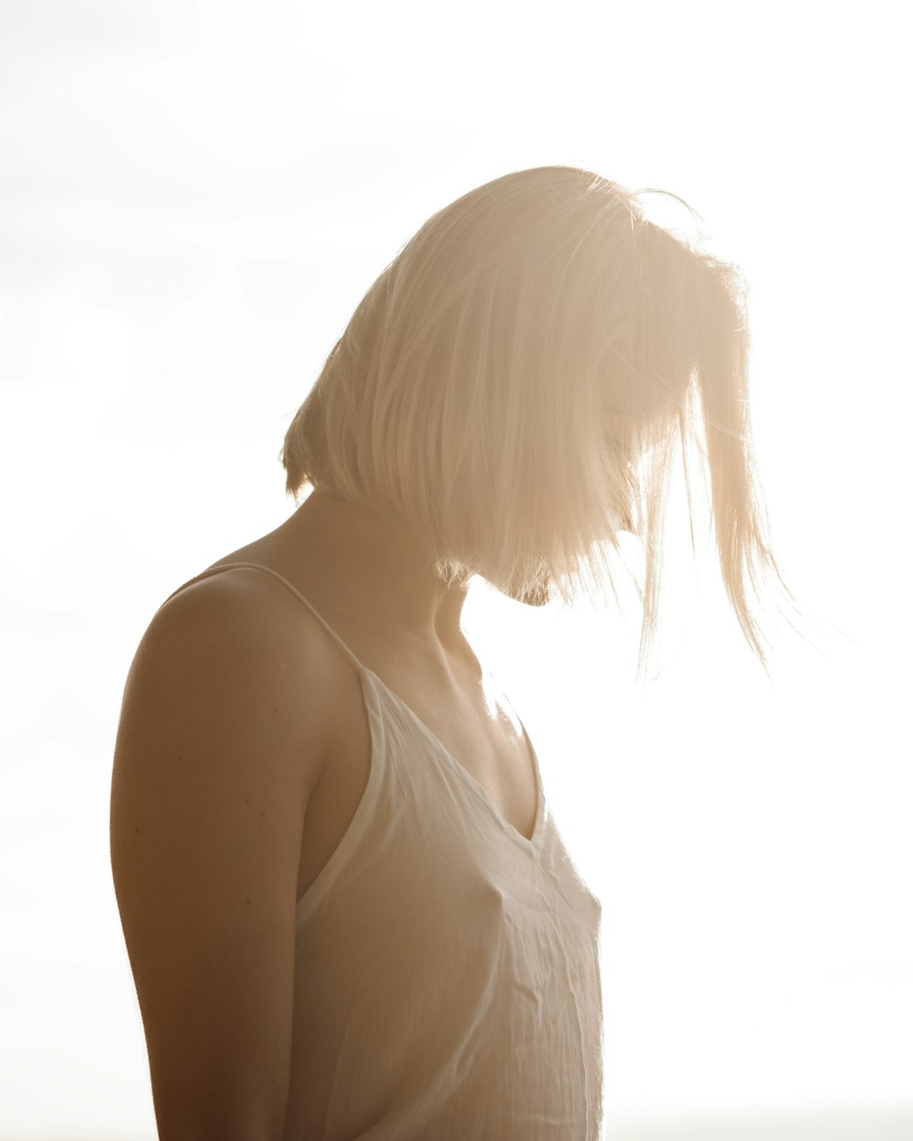 woman in white spaghetti strap top