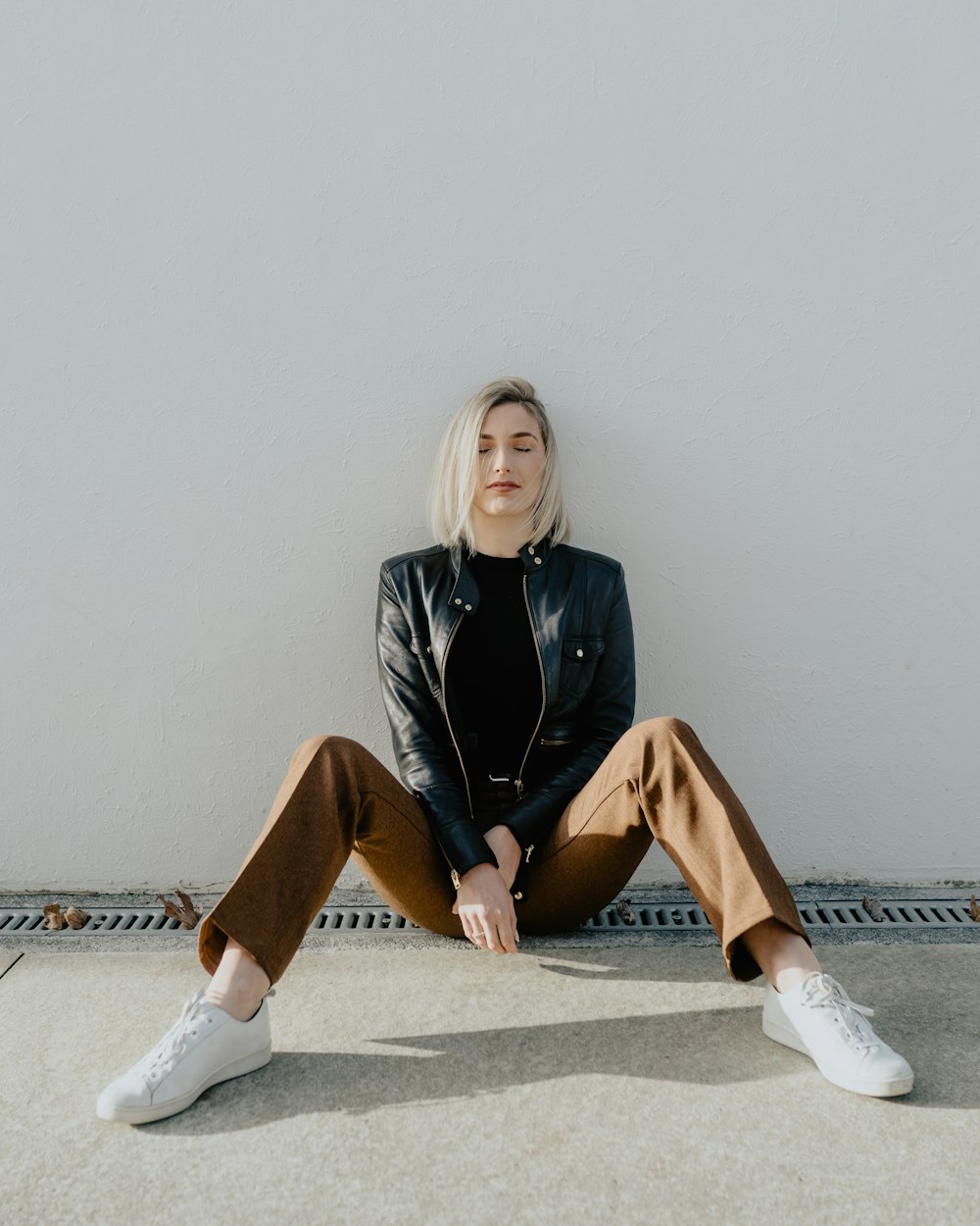 woman lying on white wall