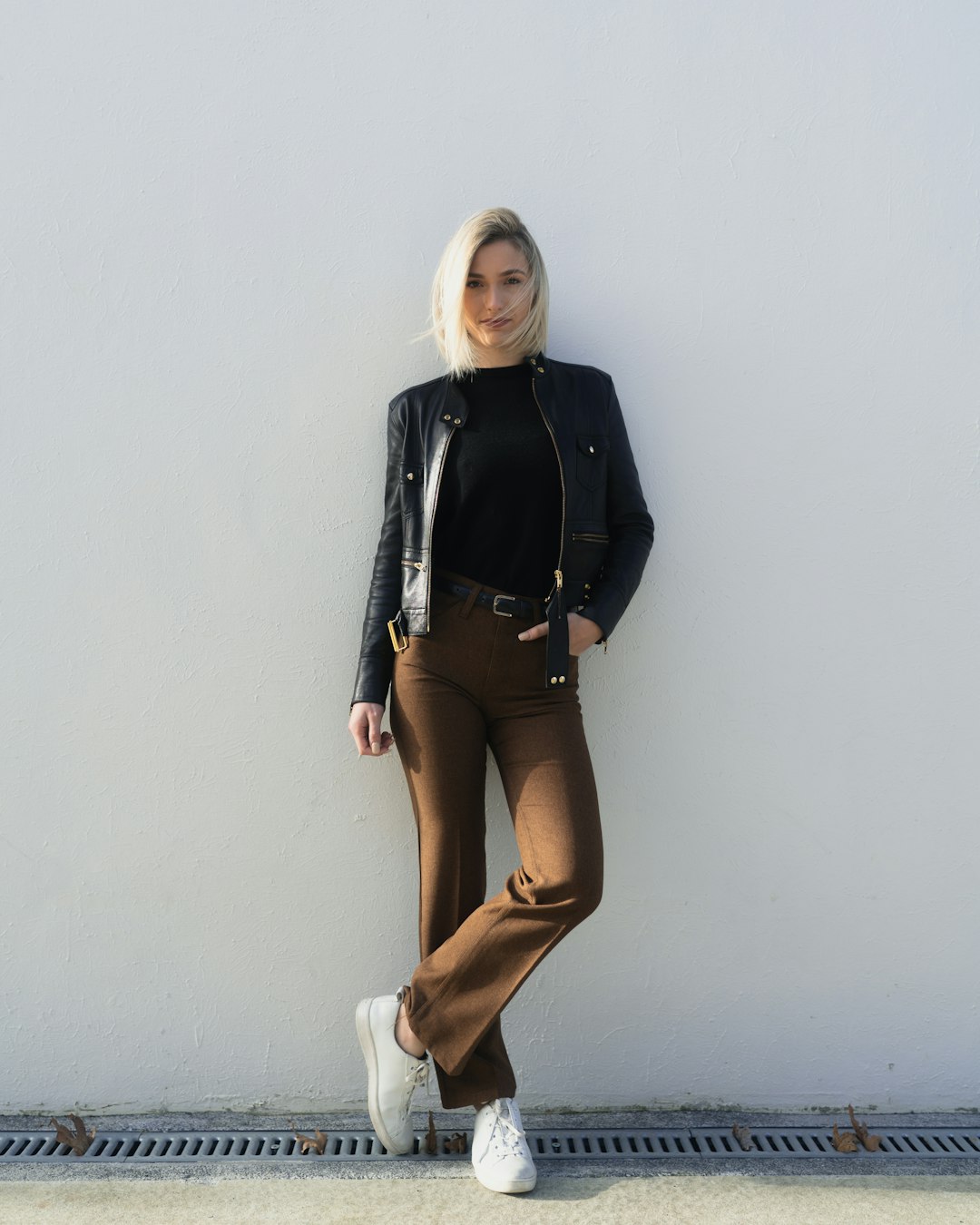 women's black crew-neck shirt and brown dress pants