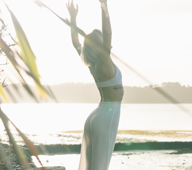 woman standing near body of water