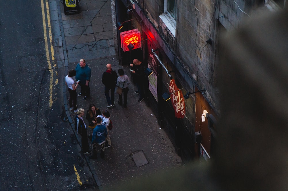 people talking near building on road