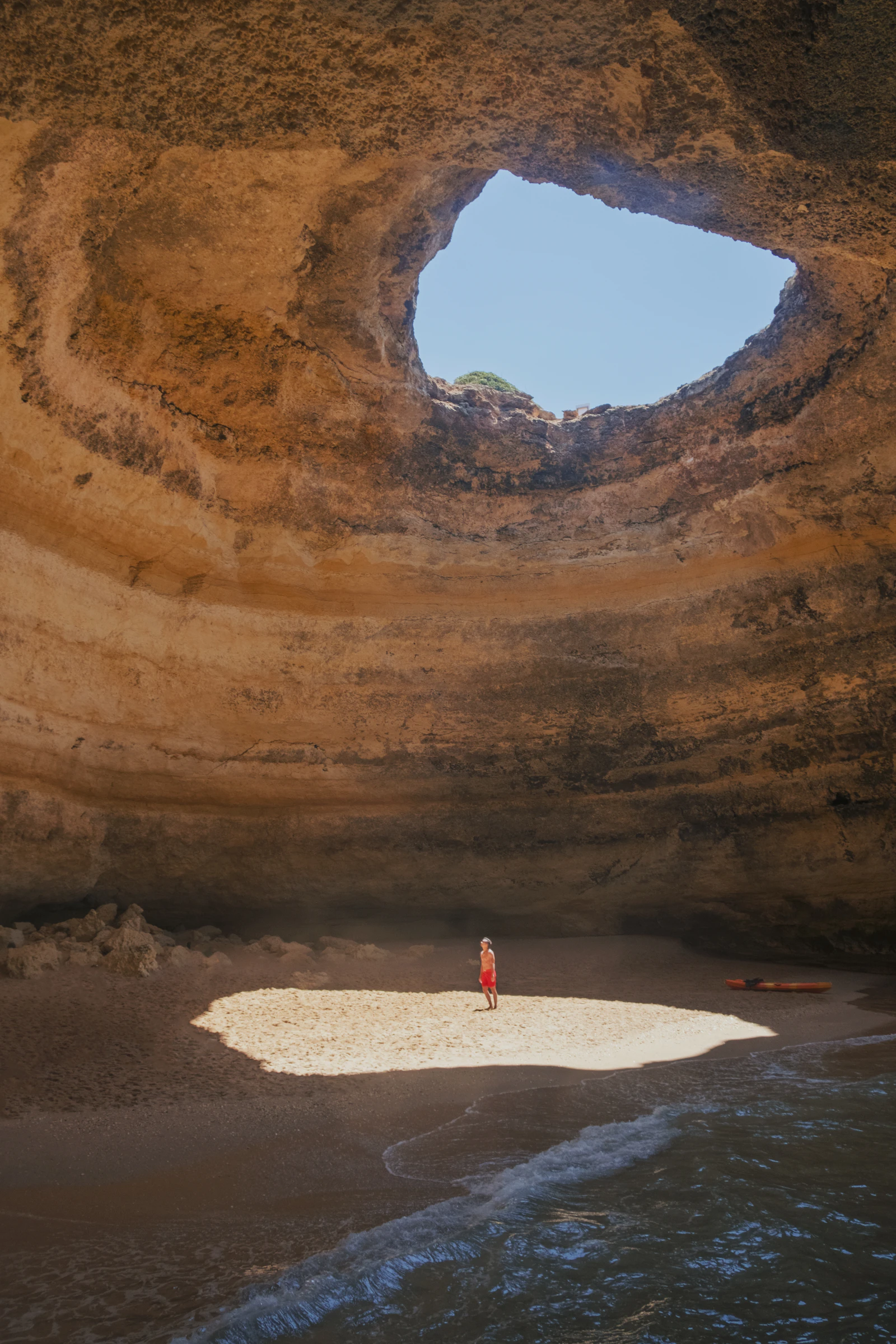A person inside Bengagil Cave in the Algarve.