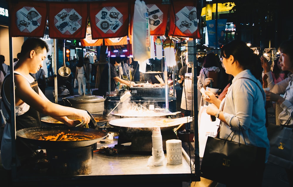 woman standing in front of food stall