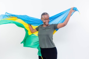 A confident adolescent girl holding a flag, symbolizing resilience and health commitment.