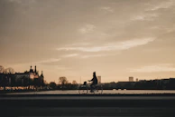 An early morning shot of Düsseldorf's skyline with a cyclist silhouetted against the rising sun.