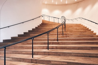 Elegant wooden staircase with smooth handrails and warm tones.