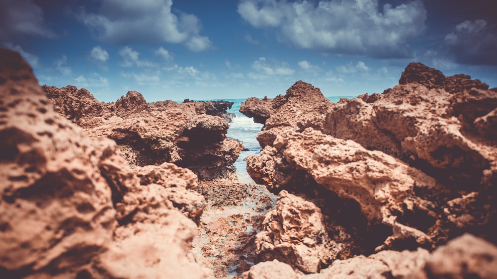 brown rock across body of water