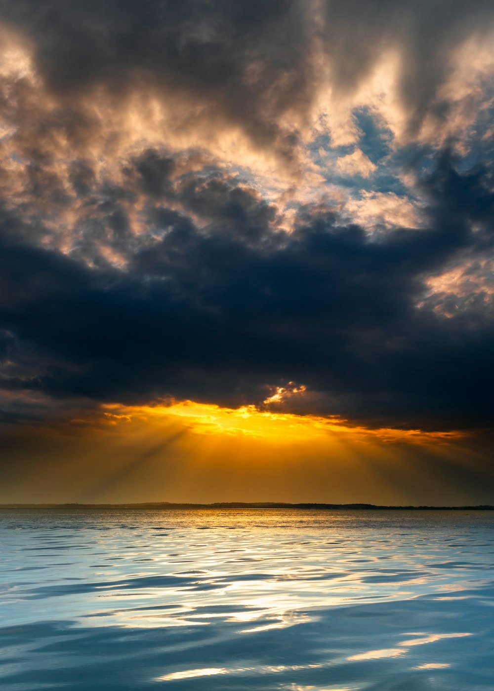 orange setting sun over sea