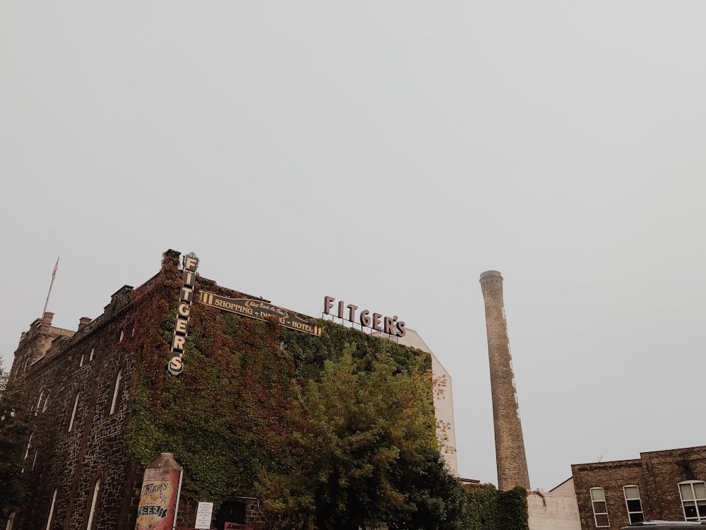 a tall brick building with a sign on top of it