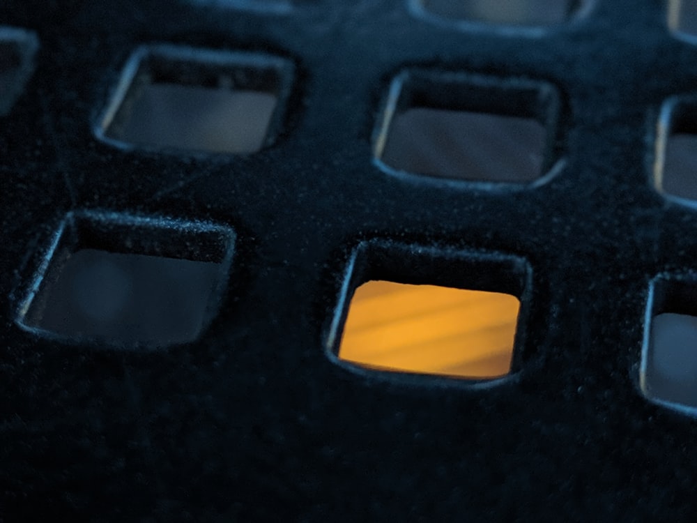 a close up of a cell phone with a yellow light