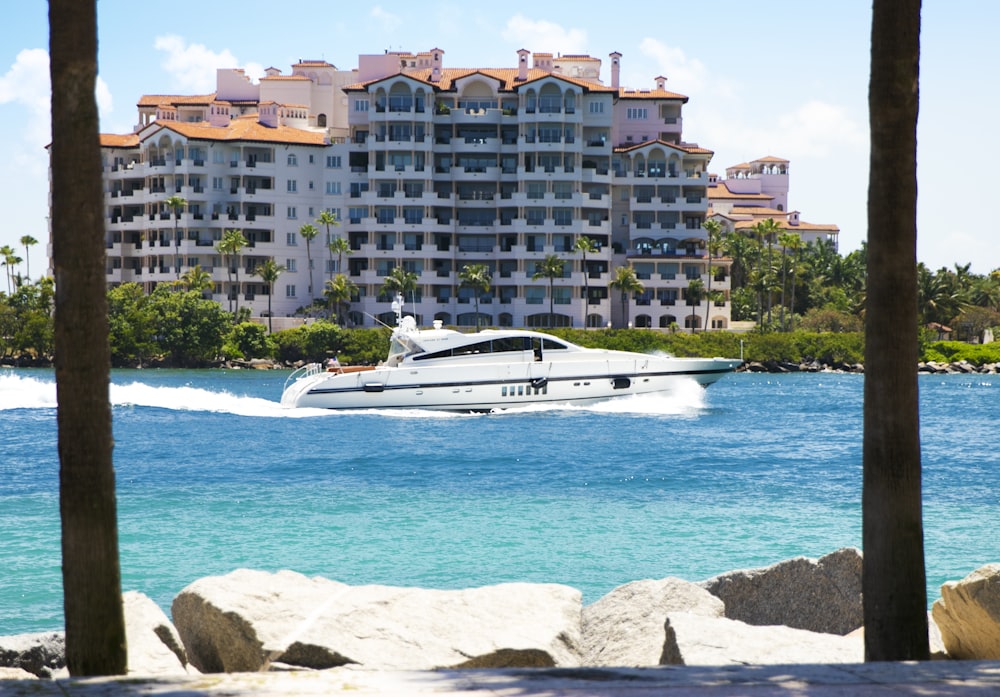 white boat on body of water at daytime