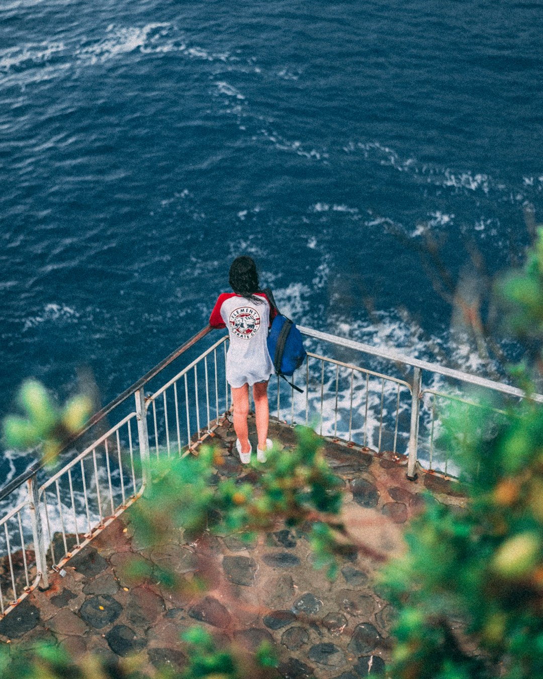 woman wearing red and white shirt looking at ocean