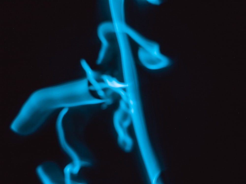 a blurry photo of a blue object on a black background